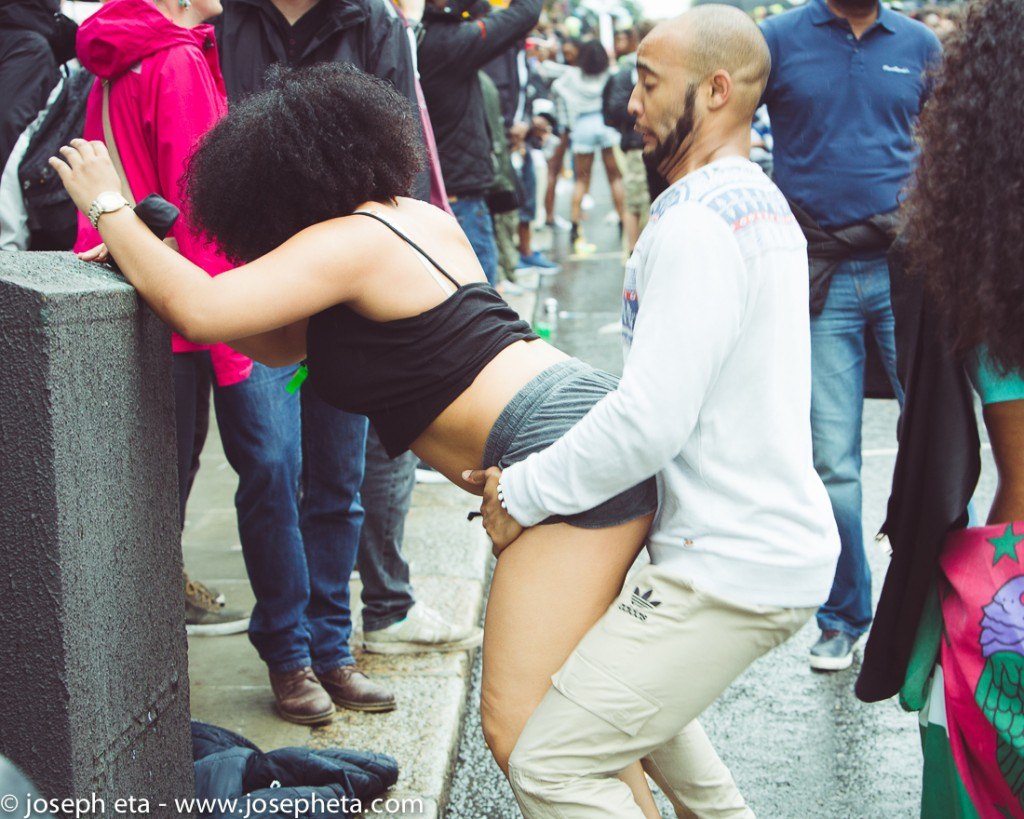 street photography of a man and a woman dancing at the London Notting Hill Carnival