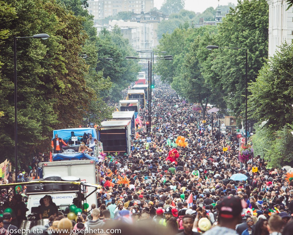 street photography of huge crowds and carnival bands and trucks going by at the Notting Hill Carnival in London