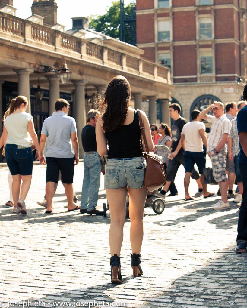 People walking across the open square in Covent Garden in London