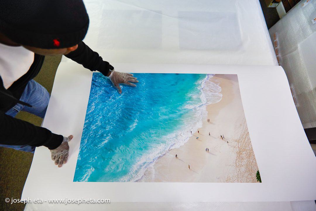 Joseph Eta inspecting of beach print from Bali, Indonesia