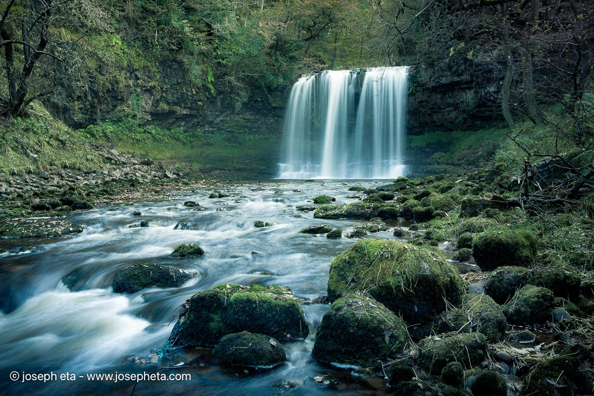 Long exposure waterfall photography. "Smoky Jade" wall art for luxury spa bathrooms and wellness spaces.