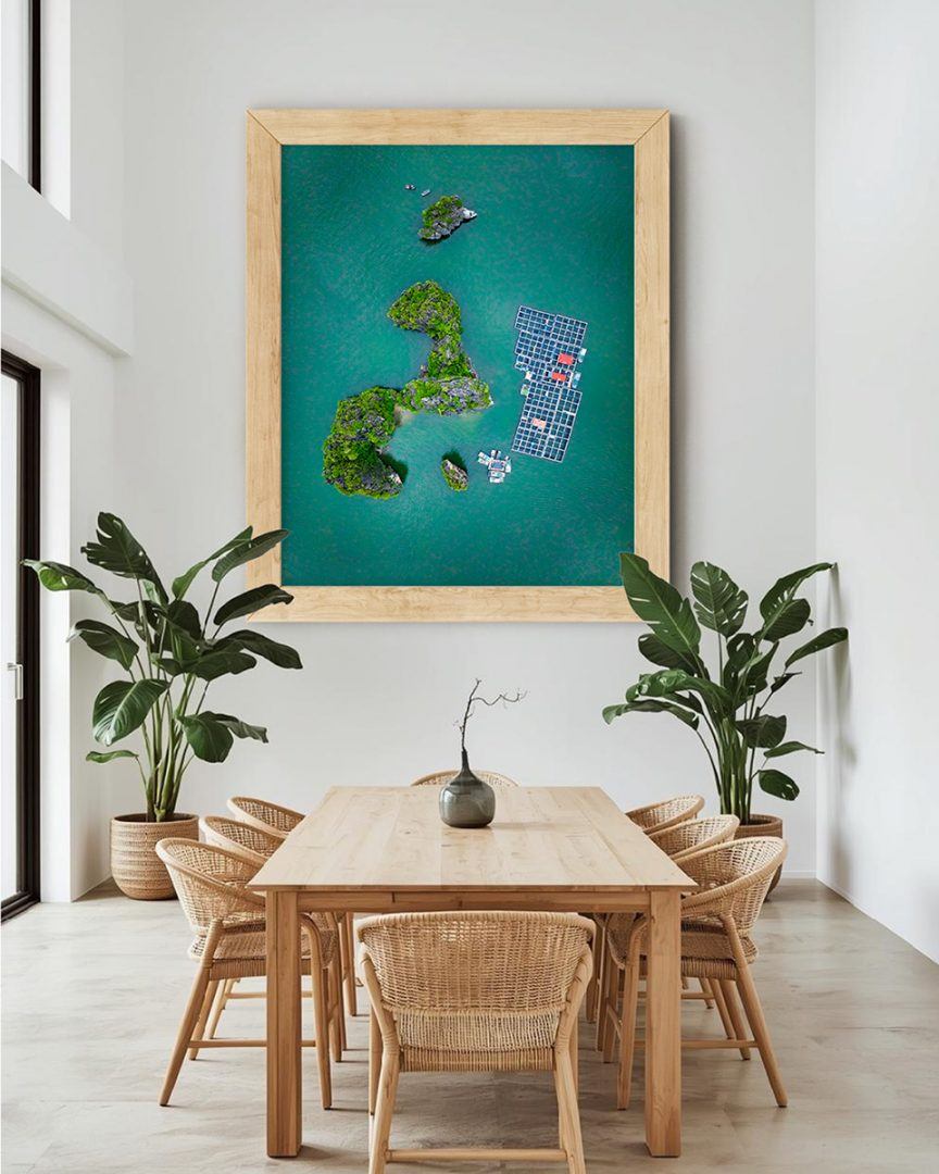 High-altitude aerial view of emerald and teal islands scattered in the ocean. Regenerative design-inspired wall art highlighting the organic beauty of nature for social spaces.