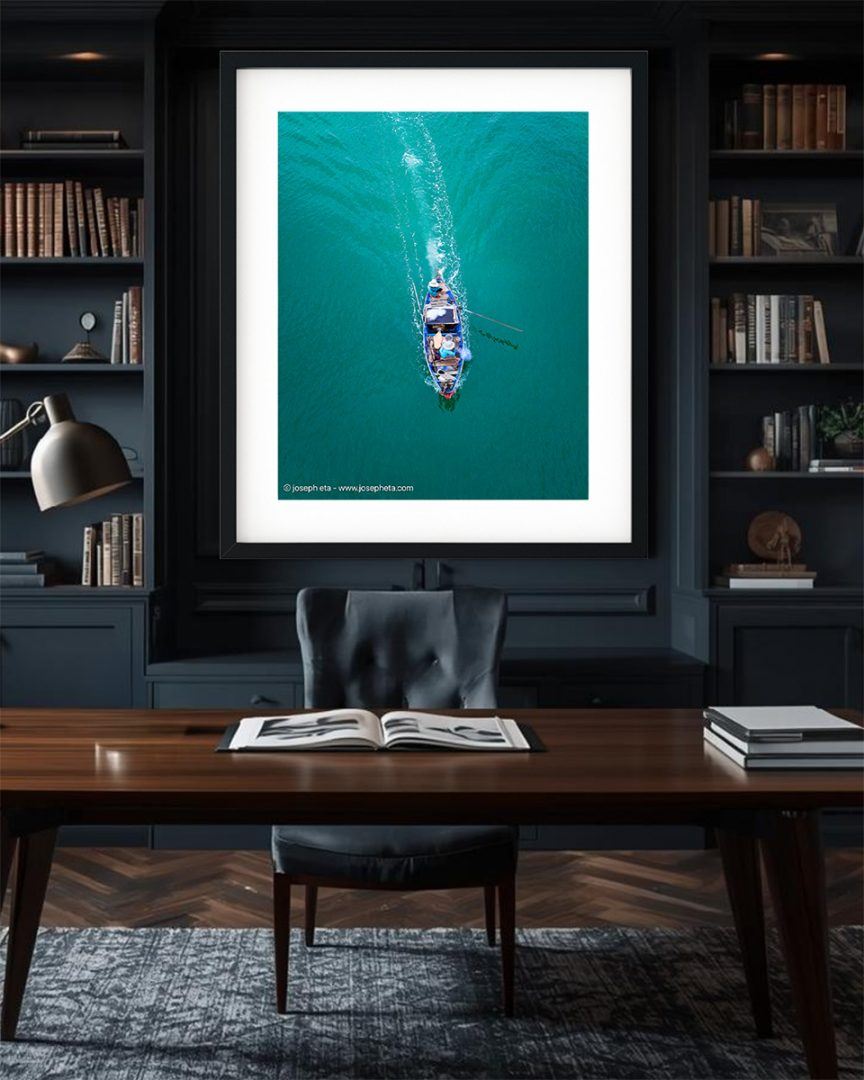 Moody deep blue aerial shot of a boat wake cutting through dark water. A sophisticated, minimalist nautical print with architectural lines, ideal for styling in home offices or libraries.