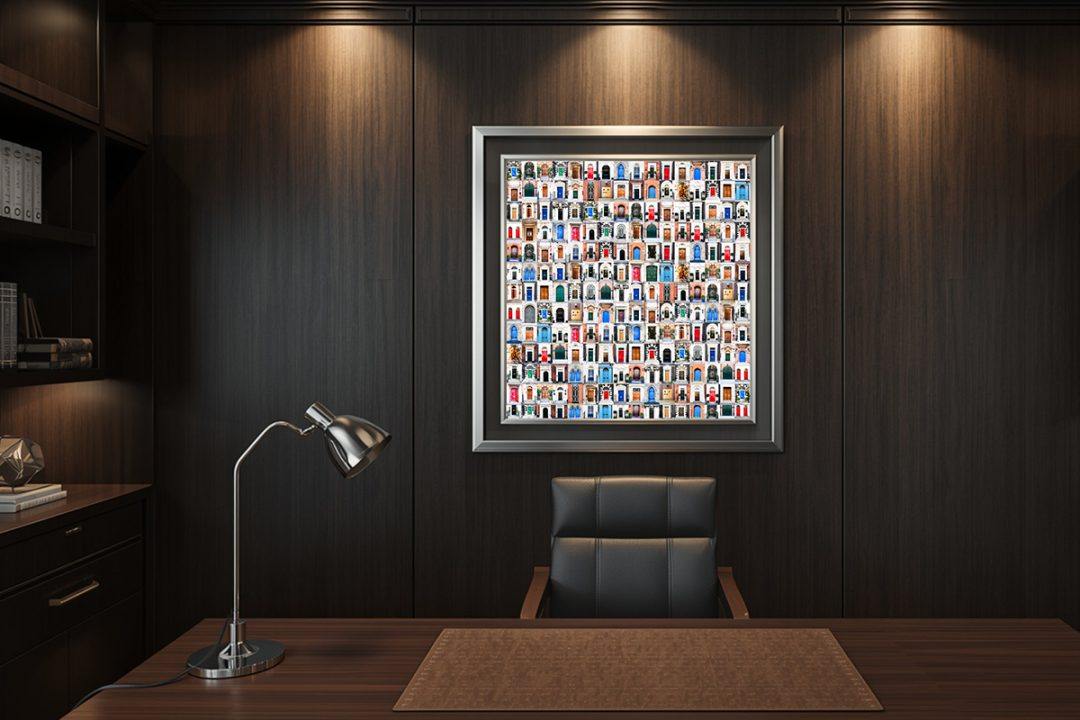 Mounted against a dark wood accent wall in an executive home office. The vibrant colors of the individual doors pop against the moody, sophisticated interior, providing endless visual inspiration during the workday.