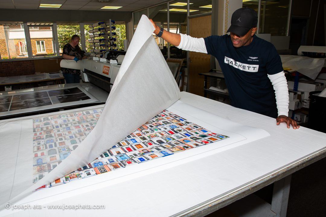 Joseph Eta in a professional photography lab, inspecting a 40x40 inch print of The Architecture Of Opportunities.