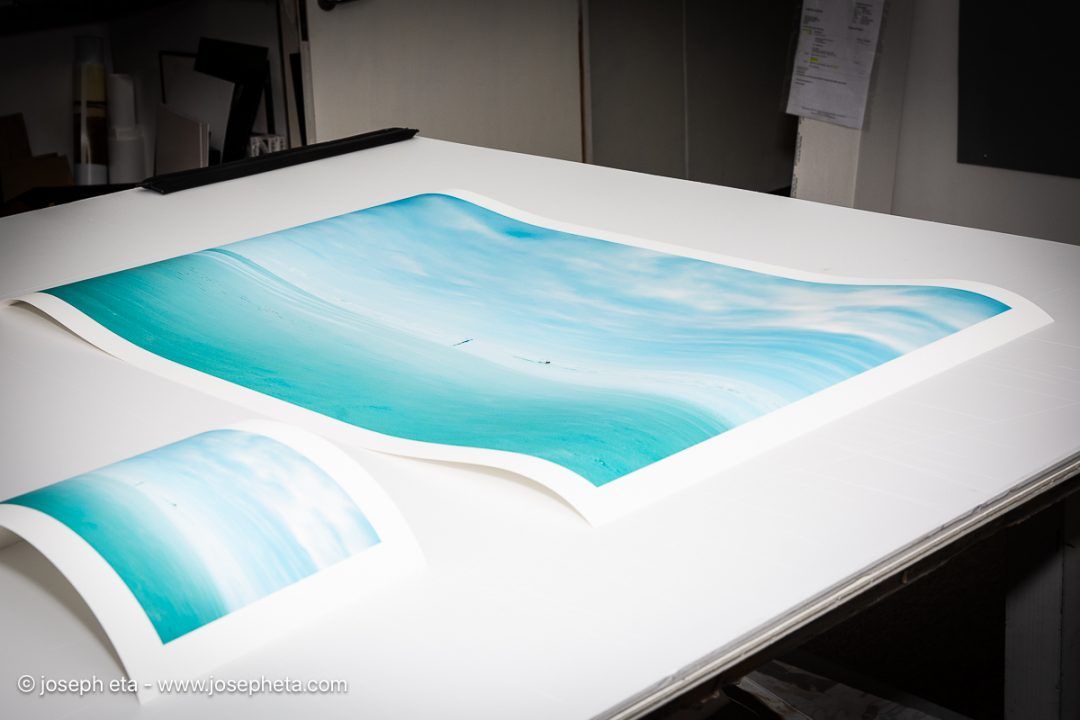 Studio View: Inspecting the museum-grade archival prints of 'The Art of Negotiation.' The varying edition scales allow the work to command spaces of different magnitudes.